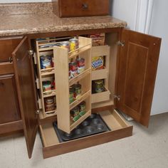 an open cabinet in the middle of a kitchen