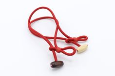 a red cord with a wooden bea on it