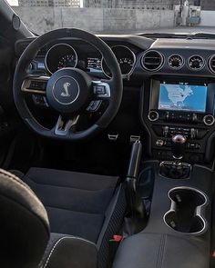 the interior of a car with black leather seats