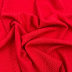 the red fabric is very soft and has been folded up to show it's texture