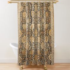 a shower curtain with an ornate design on it's side, in front of a white bathtub