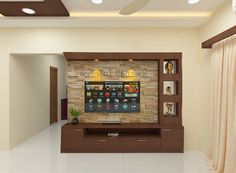 a living room filled with furniture and a flat screen tv on top of a wooden entertainment center