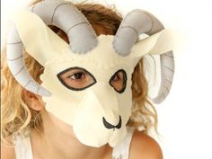 a girl wearing a goat mask with horns