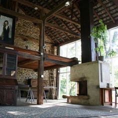 a living room filled with furniture next to a fire place in a stone walled building