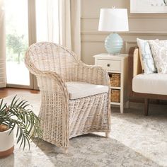 a living room with wicker furniture and large windows