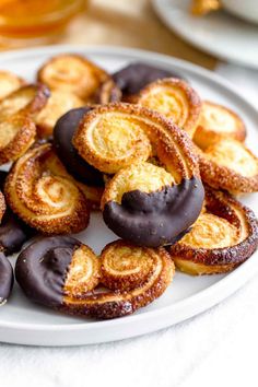 a white plate topped with chocolate covered donuts