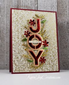 a close up of a greeting card with the word joy in red, gold and green