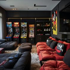 a living room filled with black couches and arcade machines