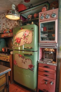 an old fashioned refrigerator in a kitchen with floral designs on the doors and drawers, along with other appliances