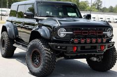 a large black truck parked in a parking lot