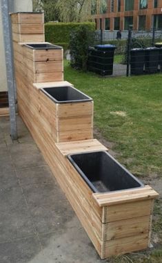 some wooden steps that have been placed in the grass and are being used as planters