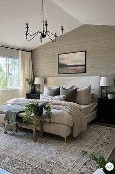 a large bed sitting in a bedroom on top of a rug next to a window