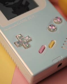 an electronic game with buttons and stickers on it