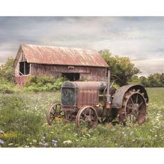 an old rusty farm tractor sitting in a field