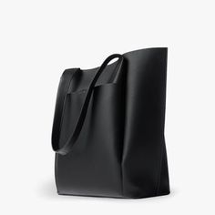 The All Day Tote is our take on the perfect bag for the go-getter. Made from our Premium Vegan Leather, it is soft to the touch and light weight. It opens up to an extra spacious interior that will can comfortably fit your everyday essentials. Carry it by the durable handle straps or over your shoulder. Perfect for wor Black Work Bags For Women, Leather Tote Bag For School, Black Work Bag, Women’s Work Bag, Tote Bag Leather Women, Black Leather Work Bag, Best Work Bags For Women, Shoppers Bag, Work Bags For Women