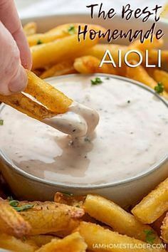 the best homemade aioli dip is in a bowl with french fries on the side