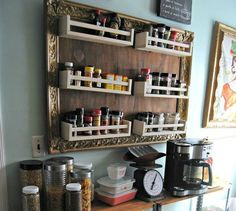 a coffee bar with spice rack and various containers on the wall above it, along with other items