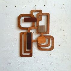 an abstract wooden sculpture on a white wall