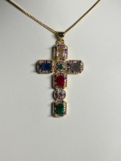 Golden cubic Zirconia cross pendant, necklace Pendant has inlaid colored zirconia stones pendant width 1 inches/2.5 cm pendant height 1 5/8 inches/4.2 cm chain length 17.5-19.5 inches / 44.5-49.5 cm comes with a golden chain as well as a gift bag beautiful colored design gives them such a unique look perfect for First Communion, Baptism, Religious celebrations, birthdays, Easter, Mother's day The colors from your monitor might vary slightly from actual colors Please have a look at the other item Unique Cross Necklace, Cute Cross Necklace, Guerriero Samurai, Baroque Necklace, Dope Jewelry Accessories, Streetwear Jewelry, Golden Chain, Jewelry Accessories Ideas, Dope Jewelry