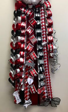 a christmas tree made out of soda cans and other items is hanging on the wall