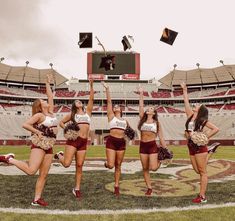 the cheerleaders are posing on the football field