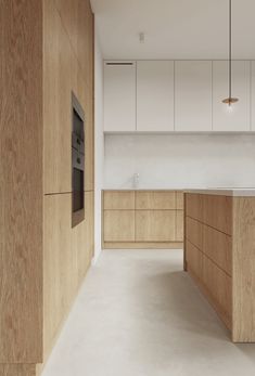 an empty kitchen with wooden cabinets and counter tops