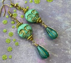 These beautiful and quirky blue/green Czech glass moons are my favorite color. I love the minty green and blue hues in these moons. They have a gold wash highlighting all their mischievous moon face details. I added teal and gold Czech glass teardrops and little gold colored beads to complement the moon faces.  Hooks are 18k gold plated brass and are nickel free. Lever backs are available upon request.  All my earrings come on a hand stamped card and are lovingly wrapped in tissue and a drawstring bag, ready to gift or keep for yourself of course!  Thank you for stopping by Laura Lingle Studio. I love ❤️ my customers!  https://www.etsy.com/shop/lauralinglestudio Whimsical Green Czech Glass Earrings, Whimsical Turquoise Nickel-free Earrings, Whimsical Green Round Jewelry, Whimsical Green Dangle Earrings, Handmade Green Whimsical Earrings, Whimsical Green Jewelry, Unique Green Czech Glass Earrings, Turquoise Jade Earrings For Gift, Whimsical Green Hypoallergenic Earrings