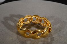 I am offering this fabulous vintage yellow gold tone bracelet. This piece is truly gorgeous, and it has the following features: *beautiful vintage bracelet *yellow gold tone *cut out design * expandable * 1 inch in width This is a fantastic and classic piece. There is tons of sparkle and shine with this piece. It will beautifully complement your upcoming fashion season. Buyer pays all shipping and handling. Bangle Jewelry, Vintage Bracelet, Cut Out Design, Bracelet Bangle, Fashion Seasons, Art Deco Jewelry, Bangles Jewelry, Vintage Bracelets, Art Deco Style