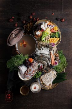 an assortment of food sitting on top of a wooden table