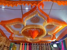 the ceiling is decorated with orange and yellow decorations