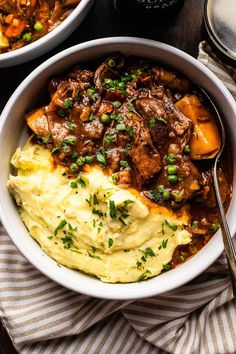 two bowls filled with meat and mashed potatoes