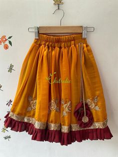 This ethnic lehenga featuring cape sleeve and jerry worked choli and tutu edged skirt accompanied with a sequienced dupatta. Please Visit My Shop For More Unique Collection https://www.etsy.com/shop/Chitralie BUYER'S PLEASE LEAVE YOUR CONTACT NUMBER. It's necessary for shipping. Fabric and Work Choli: Cape sleeve with jerry and sequence embroidered tulle fabric. The choli is lined in soft cotton fabric and ties at the back. The hanging is made with unique fabric flowers. Skirt: Gathered shimmer Festive Anarkali Sharara With Embroidered Border, Anarkali Skirt With Resham Embroidery, Festive Resham Embroidered Traditional Drape Skirt, Festive Traditional Drape Skirt With Resham Embroidery, Festive Resham Embroidery Traditional Drape Skirt, Yellow Embroidered Sharara For Eid, Festive Yellow Sharara With Embroidered Border, Navratri Long Skirt With Resham Embroidery, Festive Skirt With Resham Embroidery And Traditional Drape