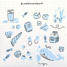 a notebook with blue ink on it and various items drawn by hand in front of the page