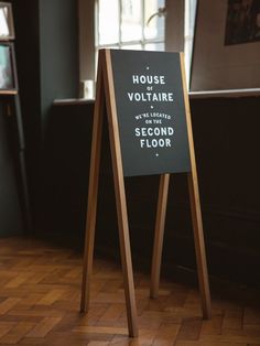 a sign that says house voltaire on the second floor