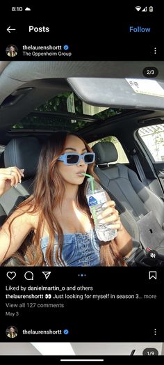 a woman sitting in the back seat of a car holding a bottle of water