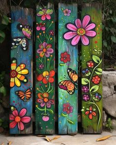 painted wooden boards with flowers and butterflies on them