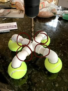 four tennis balls are placed on top of each other in the shape of an x