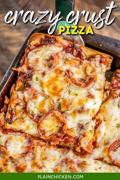 a pan filled with pizza sitting on top of a wooden table