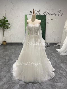 a white wedding dress on display in a store