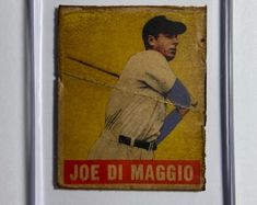 an old baseball card with a man holding a bat in his right hand and the words joe di maggio on it