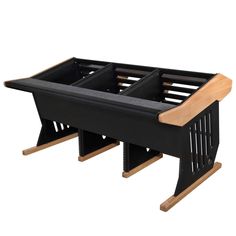 a wooden table with two black trays on it