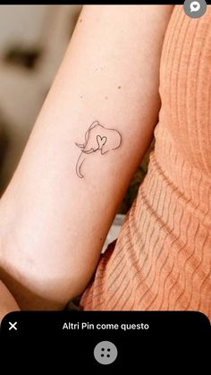 a woman's arm with a small tattoo on the left side of her arm