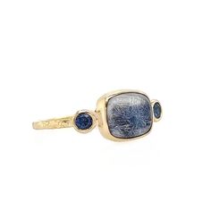 The ethereal cornflower blue of this Dumortierite quartz is as beautiful as it is interesting. Set with a pair of Periwinkle blue Sapphires to highlight the unique coloring of this beauty, finished with hand textured gold band and gold bezel. Approximate center stone size: 7mm x 8mm Approx ct weight: 2.3cts Mohs Hardness: 7 This one of a kind piece is handmade with love in Emily's Hudson Valley studio. If you have questions about sizing, shipping or need help deciding on your perfect piece pleas Blue Cabochon Sapphire Ring In 14k Gold, Blue Cabochon 14k Gold Ring, 14k Gold Blue Cabochon Rings, Blue Cabochon Sapphire Ring, Blue Cabochon Sapphire Ring In Fine Jewelry Style, Fine Jewelry Blue Cabochon Sapphire Ring, Celestial Style Cabochon Yellow Gold Rings, Celestial Yellow Gold Cabochon Rings, Unique Blue Cabochon Moonstone Ring