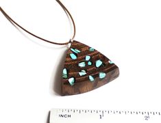 Fine necklace made of exotic wood burl and natural turquoise inlay. Size/Dimensions height - 1 2/8 inch / 32 mm The length of the cord is about 30 inches (77 cm), but it can be regulated by movable knot. Materials utilised Turquoise, exotic burl wood, cord Production method 100% hand made by natural materials. ABOUT ME My name is Nikolin Georgiev and I live in Sofia, Bulgaria. I love creating beauty therefore I make jewelry. I love colours and stones' emanation. I also love the soft warmth of wo Bohemian Wood Necklace As Gift, Bohemian Wood Necklace For Gift, Bohemian Wood Necklaces Perfect For Gifts, Bohemian Wooden Necklace For Gift, Bohemian Wood Necklace Perfect As A Gift, Unique Brown Resin Necklaces, Handmade Artisan Wood Jewelry, Artisan Resin Pendant Necklace, Artisan Handmade Wooden Jewelry