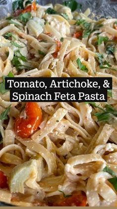 a close up of a plate of food with noodles and tomatoes on it, including parsley