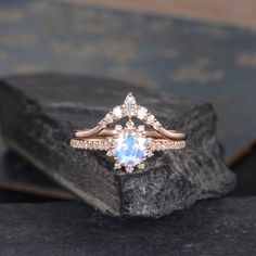 a diamond ring sitting on top of a rock