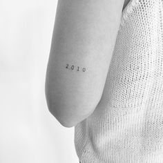 a woman with a small tattoo on her arm