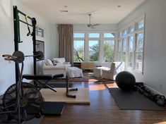 a living room filled with furniture and gym equipment