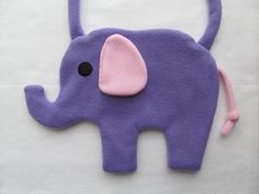 an elephant is made out of felt on a white surface