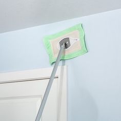 a mop is being used to clean the ceiling